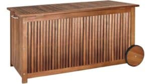 Eine stilvolle und funktionale rechteckige Deuba-Aufbewahrungsbox mit Lattenholzseiten, einem Klappdeckel, Metallgriffen und einem großen Rad auf der rechten Seite für einfache Mobilität.